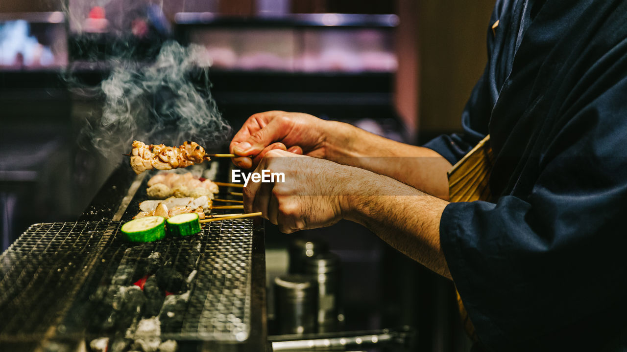 Close-up of man preparing food