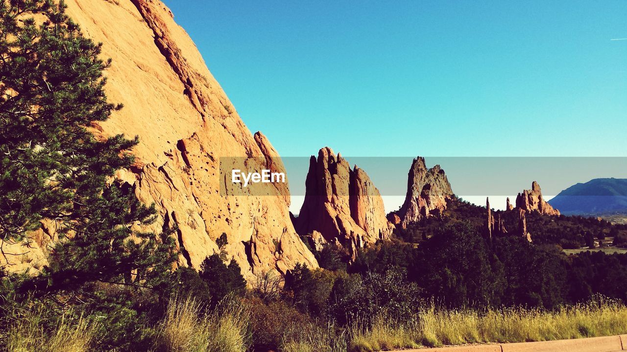 Low angle view of mountain and field against sky