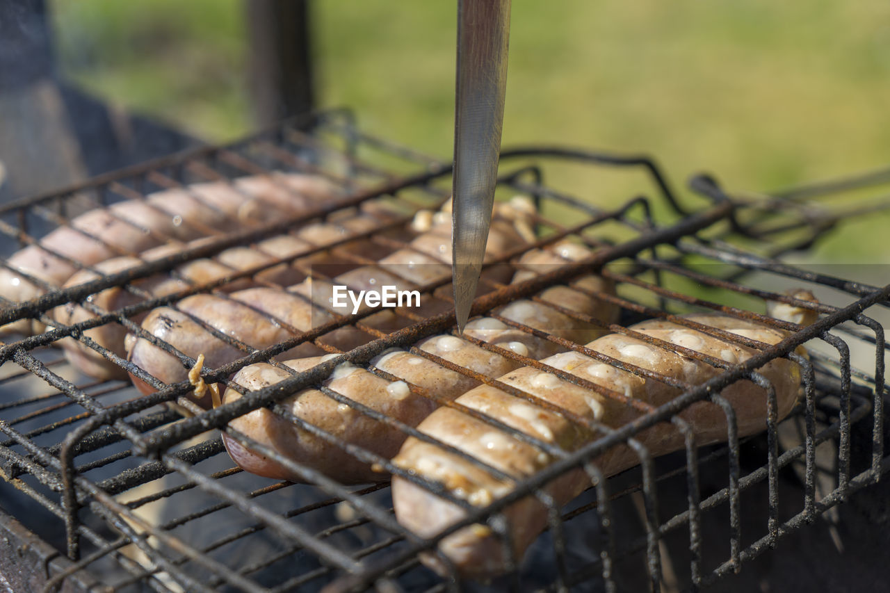 Chicken sausages on the grill. cooking at the stake. close-up.