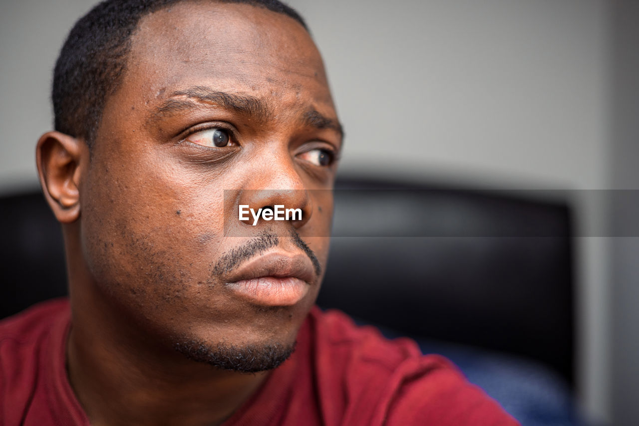 portrait, headshot, adult, one person, person, indoors, serious, men, human face, looking, close-up, lifestyles, contemplation, facial hair, human head, relaxation, casual clothing, front view, buzz cut, human hair, focus on foreground, emotion, mature adult, copy space, looking at camera, beard, shaved head, brown eyes, concentration, hairstyle, individuality