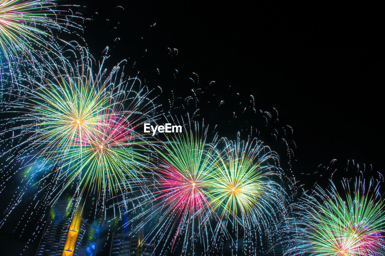Low angle view of colorful firework display against sky at night
