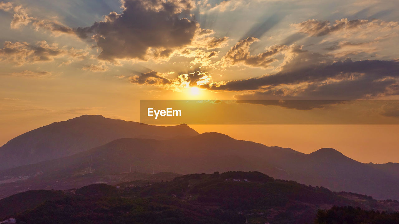 Scenic view of silhouette mountains against sky during sunset