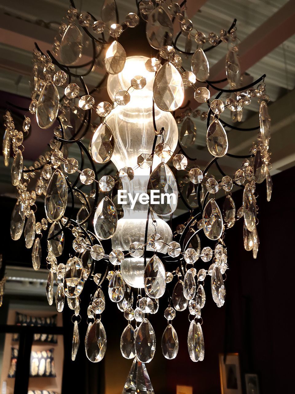 LOW ANGLE VIEW OF ILLUMINATED CHANDELIER