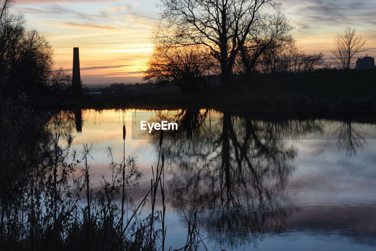 SCENIC VIEW OF LAKE AGAINST ORANGE SKY