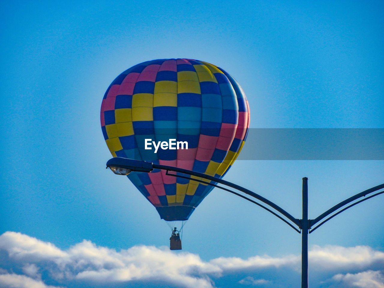 LOW ANGLE VIEW OF HOT AIR BALLOONS FLYING AGAINST BLUE SKY