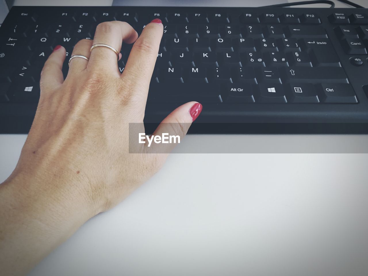 CLOSE-UP OF HAND USING LAPTOP