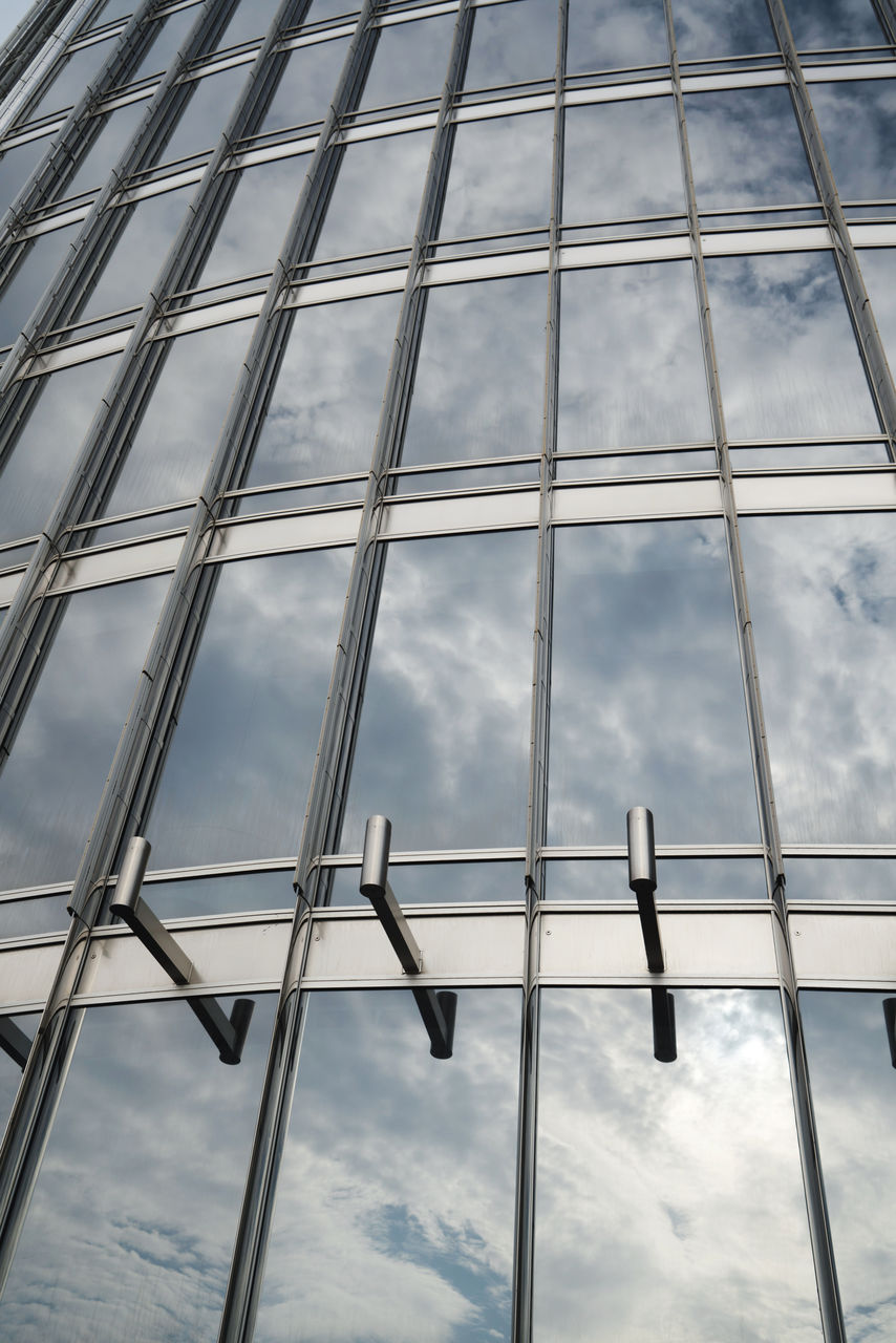 Low angle view of glass window against sky