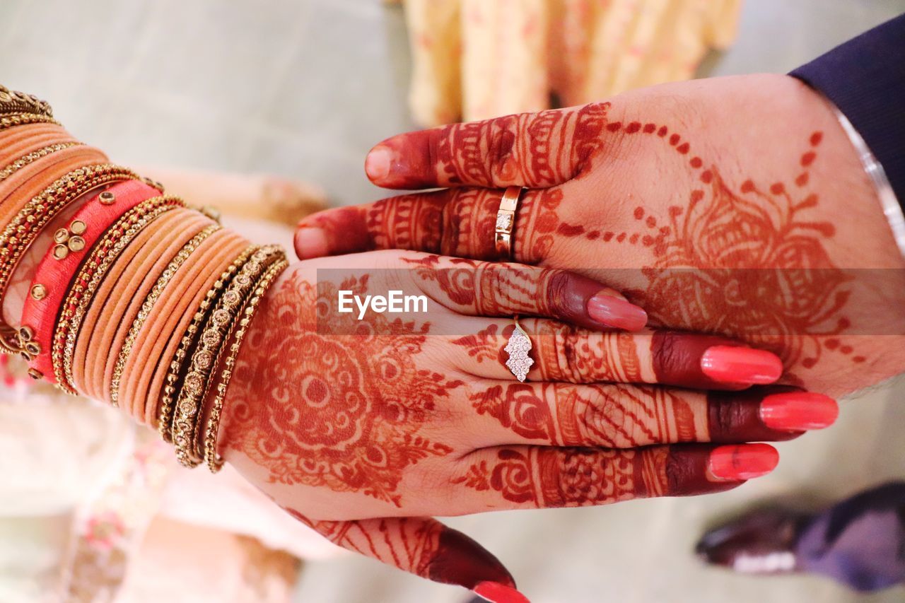 Low section of woman with tattoo on hands