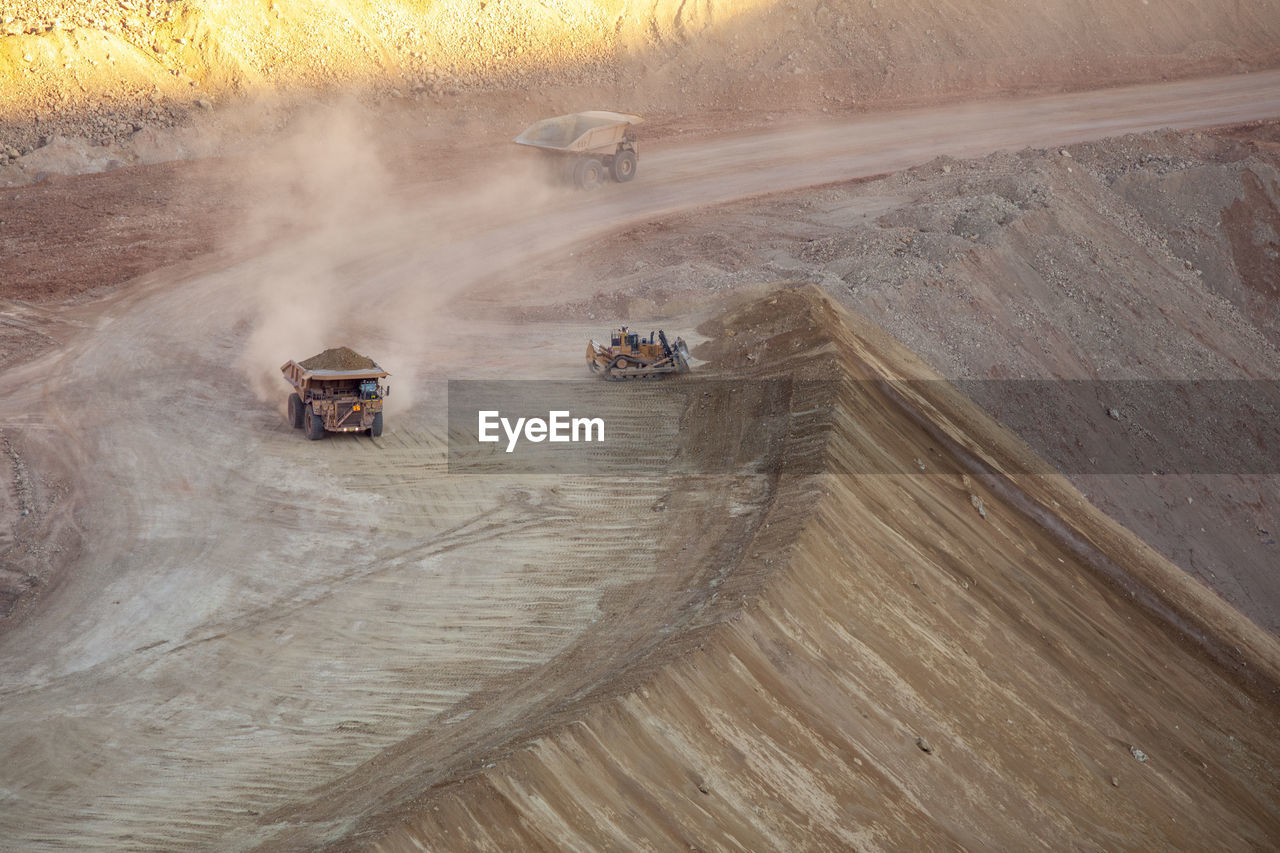 Dump trucks stir up dust hauling dirt mining morenci, arizona