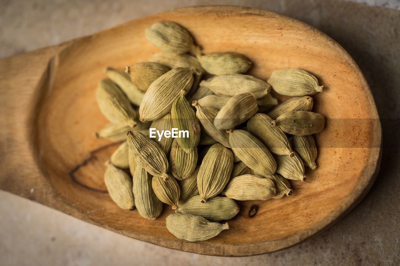 Close-up of cardamoms in spoon