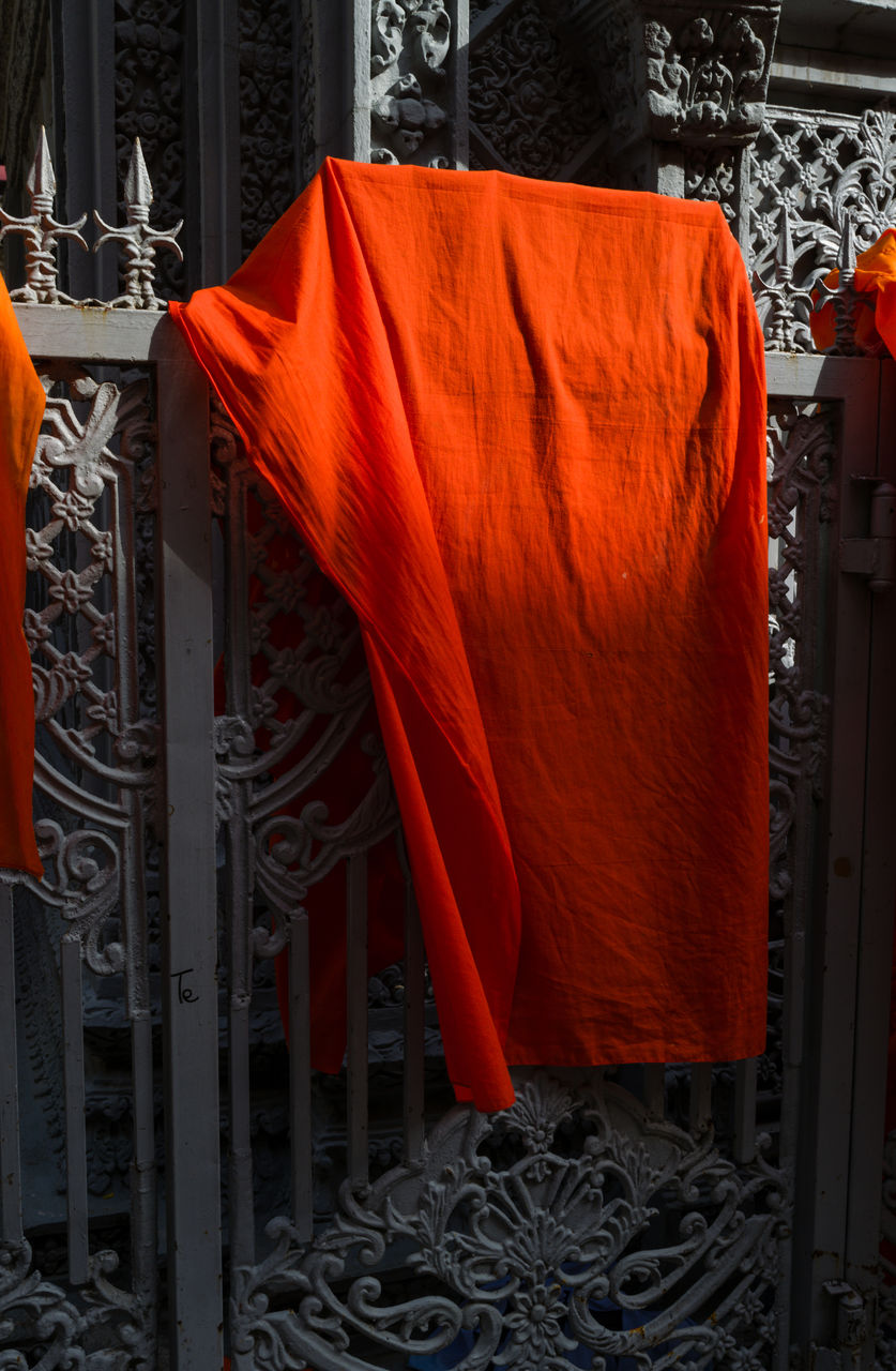 Orange buddhist monks clothing hanging down in the pagoda