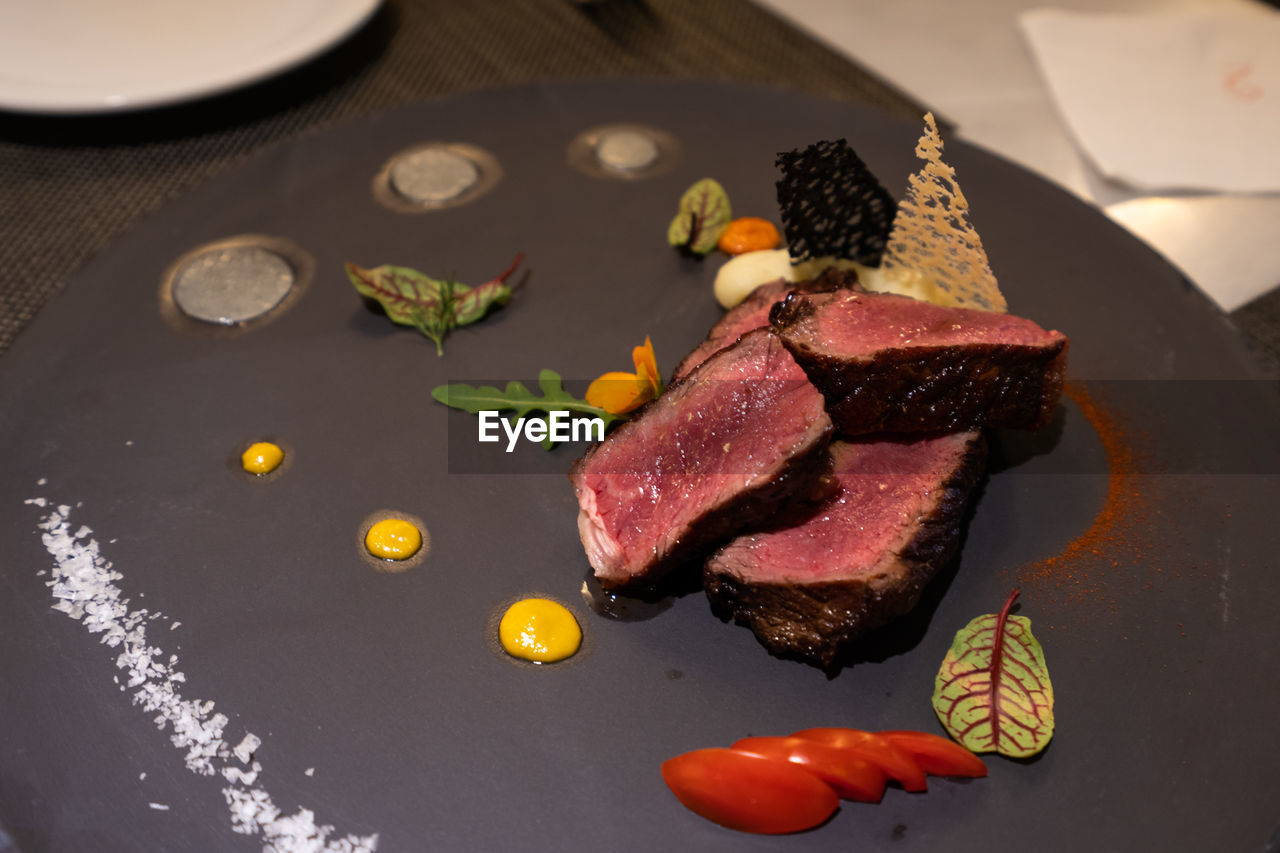 High angle view of steak served on plate