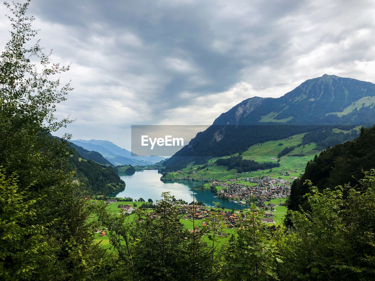 Scenic view of lake and mountains against sky