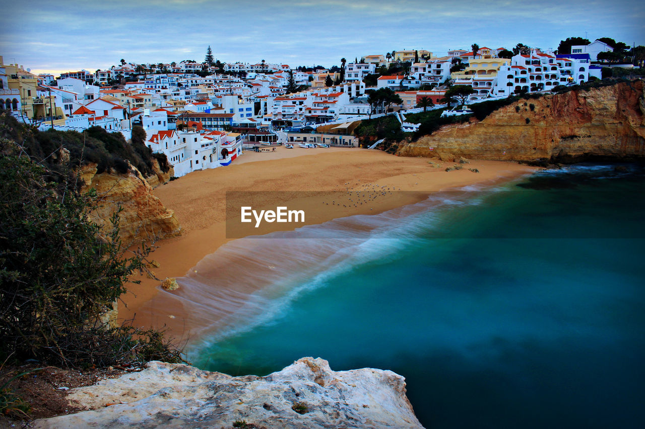 water, coast, sea, land, architecture, beach, ocean, nature, building exterior, travel destinations, city, sky, shore, body of water, built structure, landscape, wave, building, scenics - nature, travel, environment, coastline, beauty in nature, bay, tourism, outdoors, rock, terrain, no people, cloud, reflection, cliff, cityscape, blue, house, trip, vacation, high angle view, holiday, mountain, residential district, sports