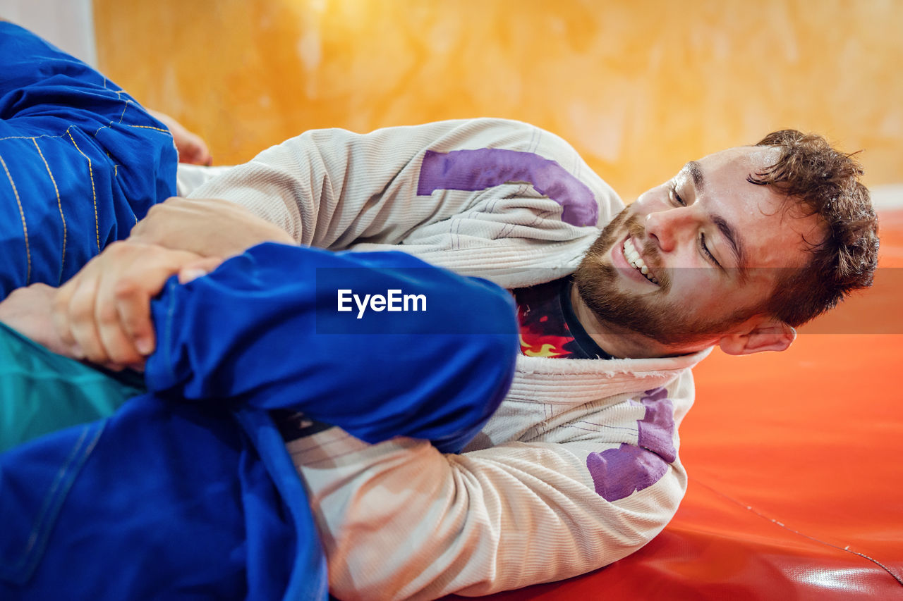 PORTRAIT OF MAN RELAXING ON BED