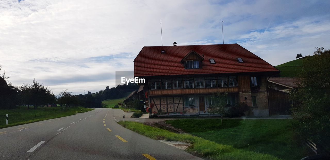 ROAD BY BUILDINGS AGAINST SKY IN CITY