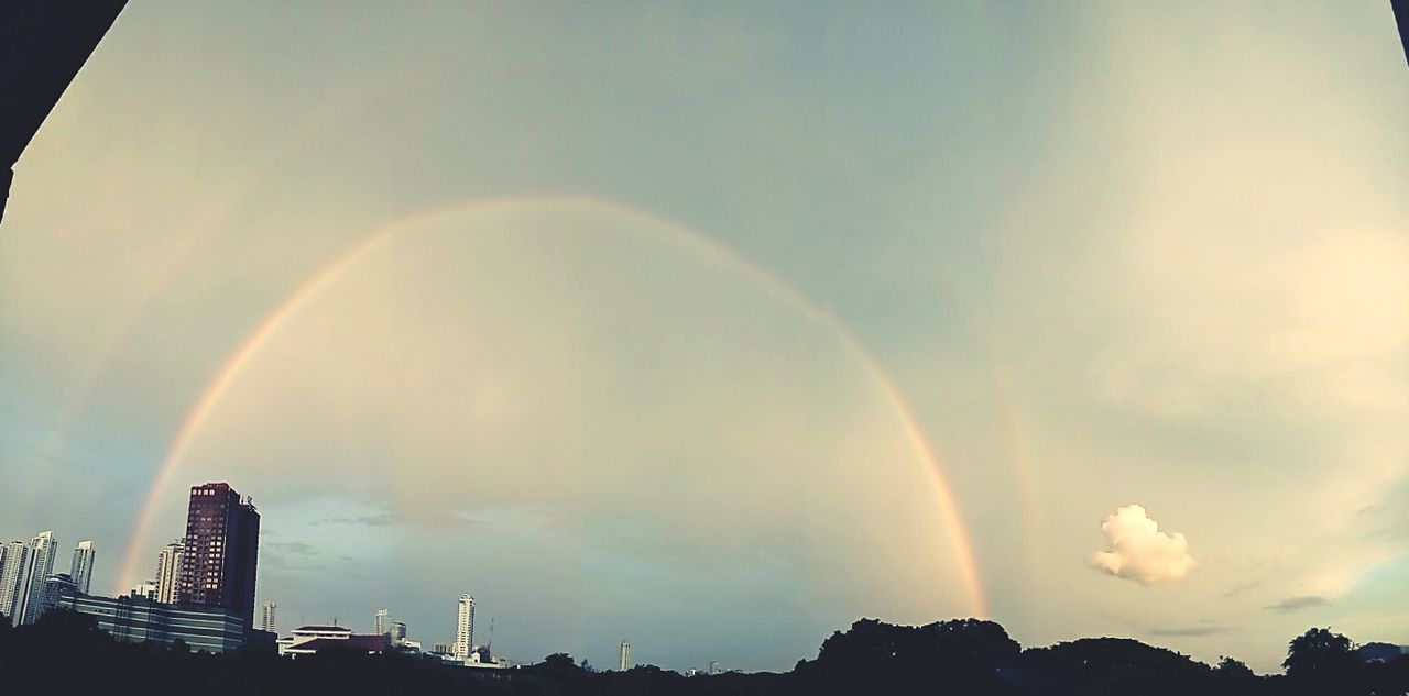 LOW ANGLE VIEW OF RAINBOW OVER CITY