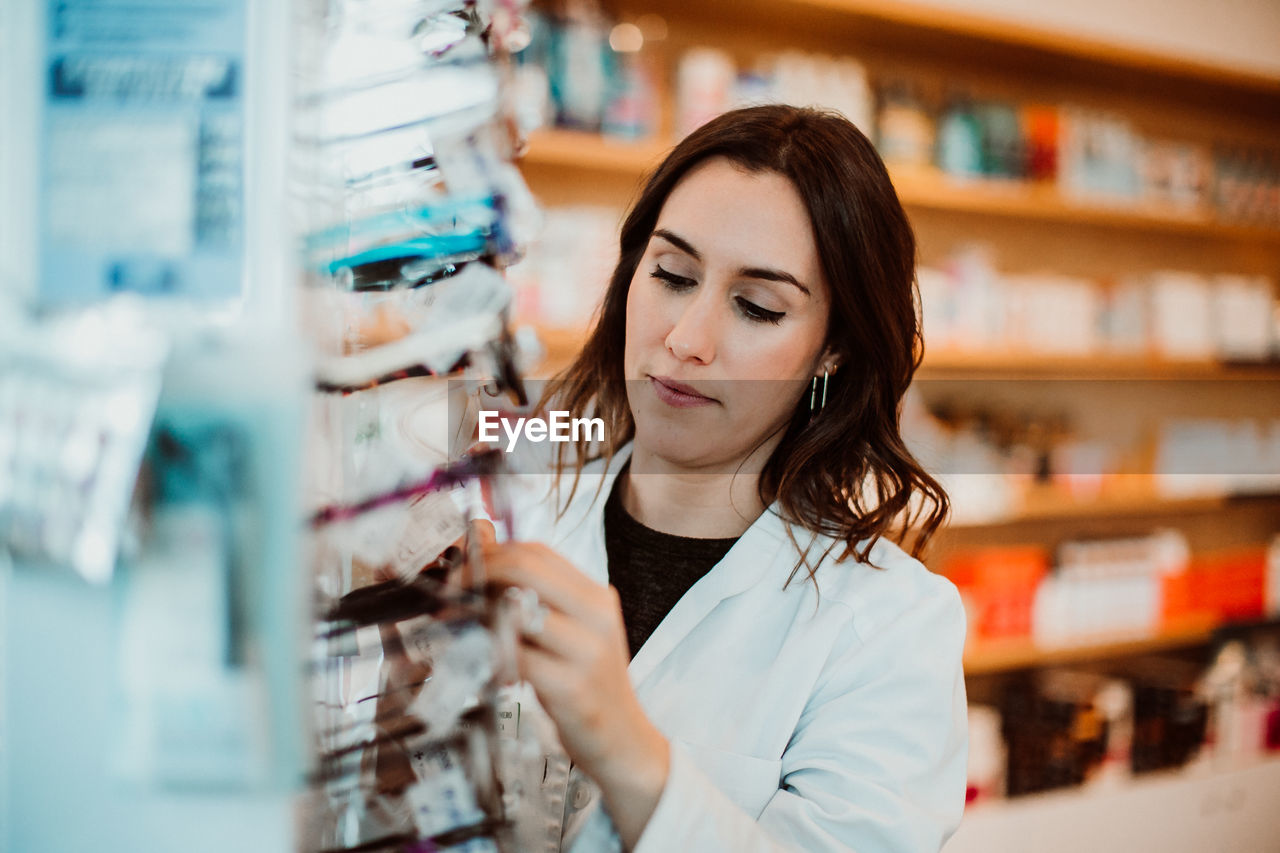 Female optometrist working at store