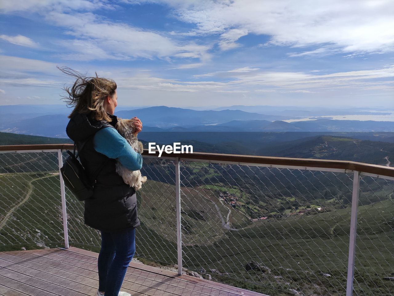 Full length of woman standing on mountain against sky