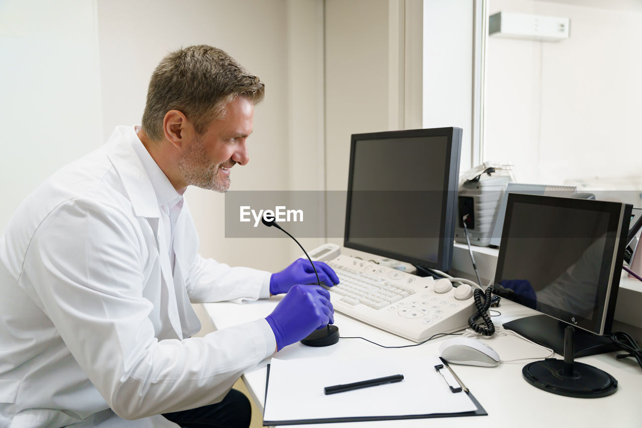 side view of man working at clinic