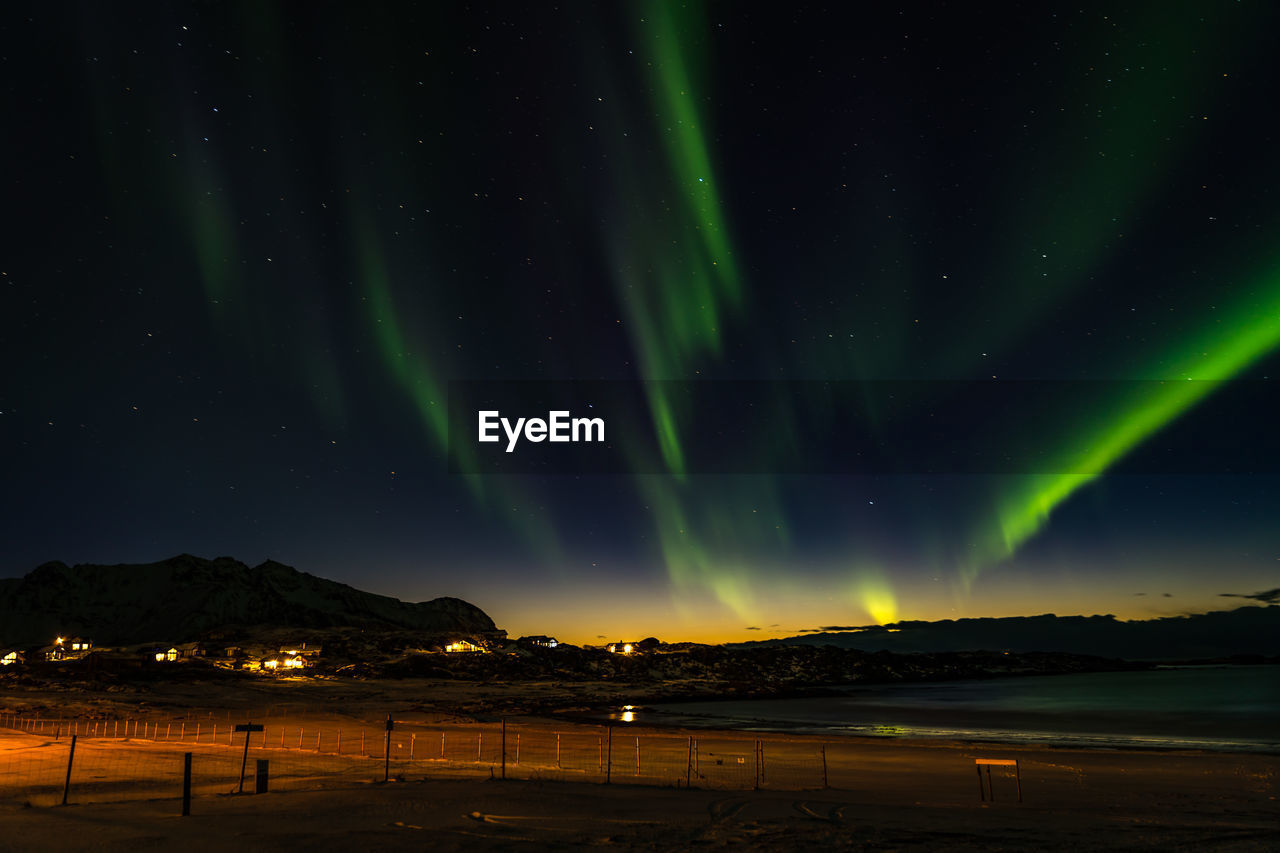 Scenic view of mountains against sky at night with northern light 
