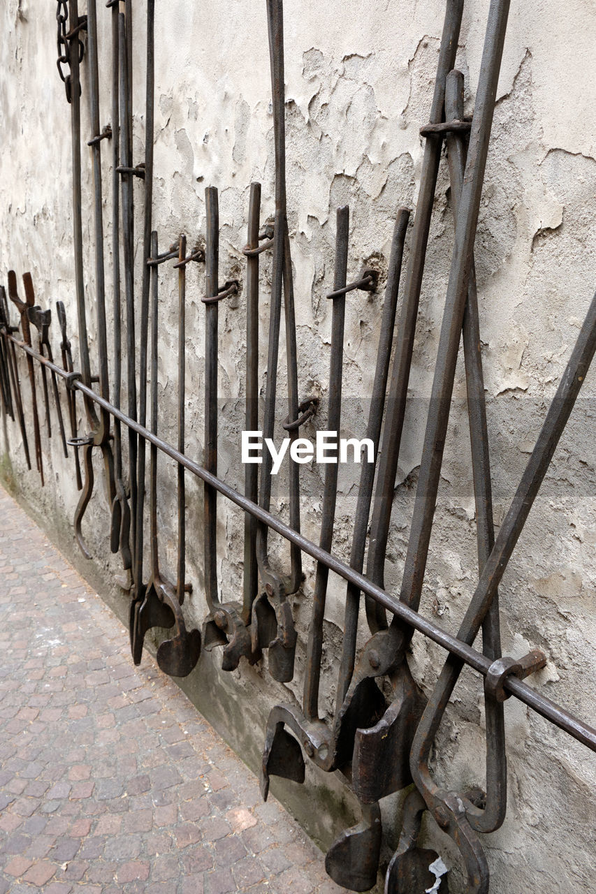 Close-up of metallic rod against wall