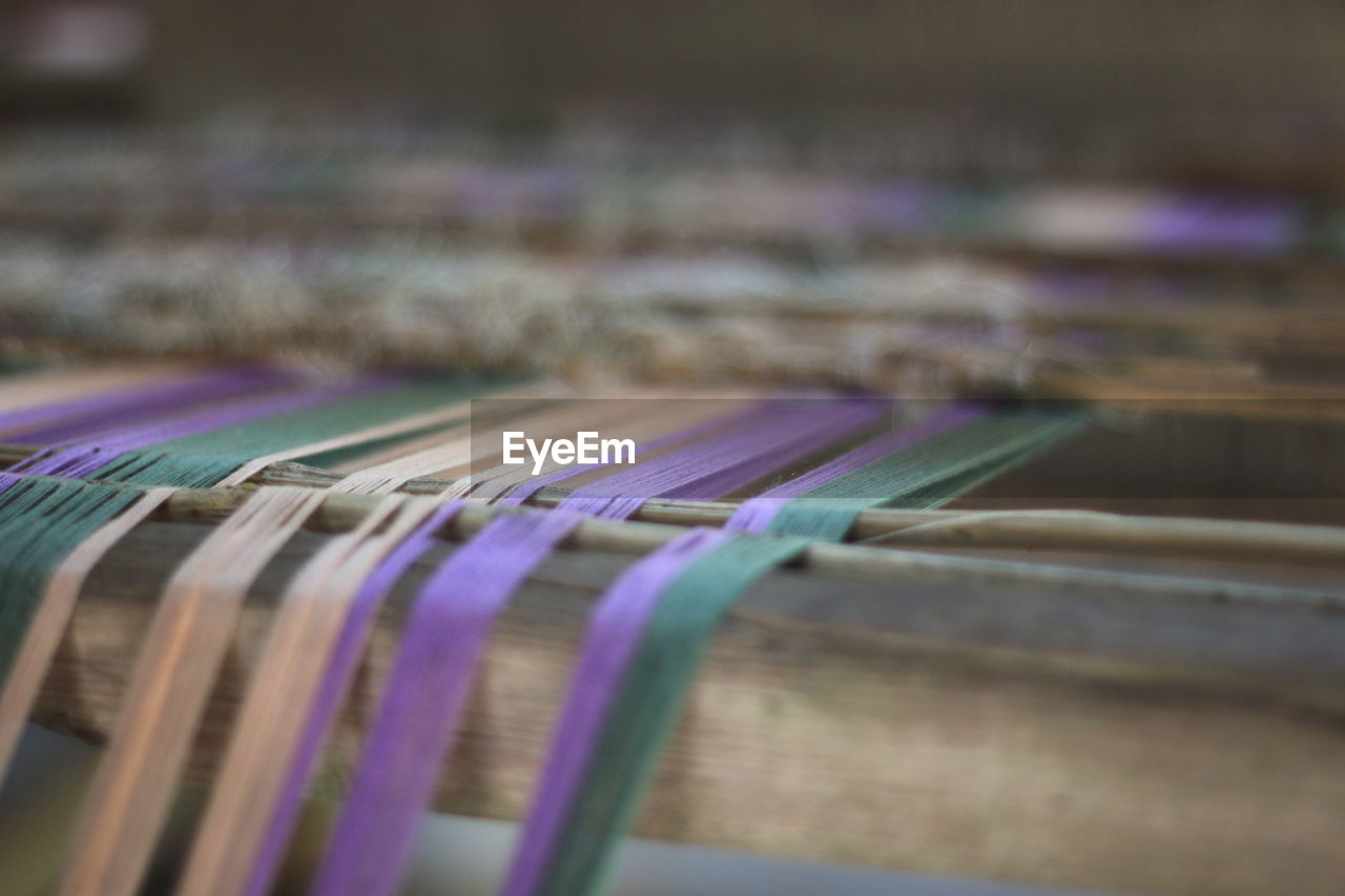 Close-up of colorful threads on loom