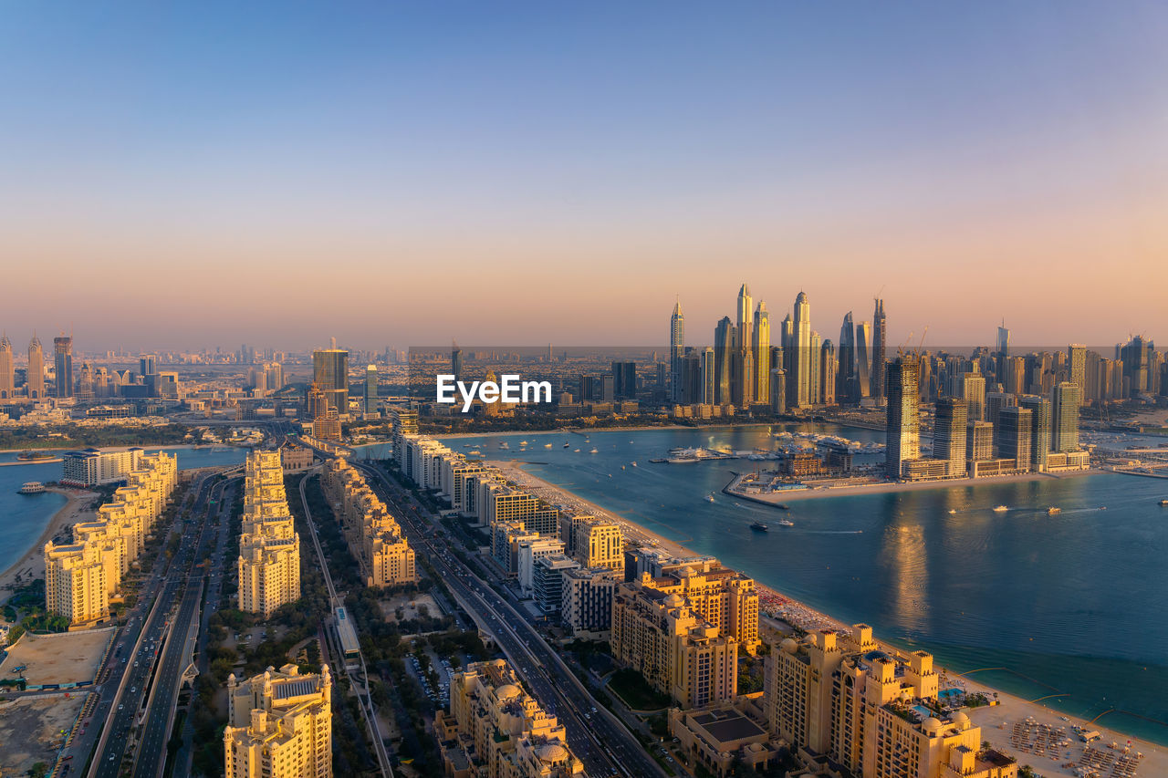 high angle view of cityscape against clear sky during sunset