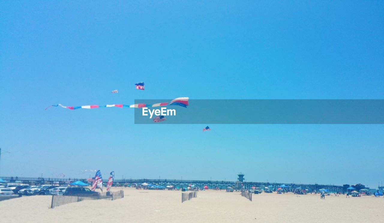 Scenic view of beach against clear blue sky