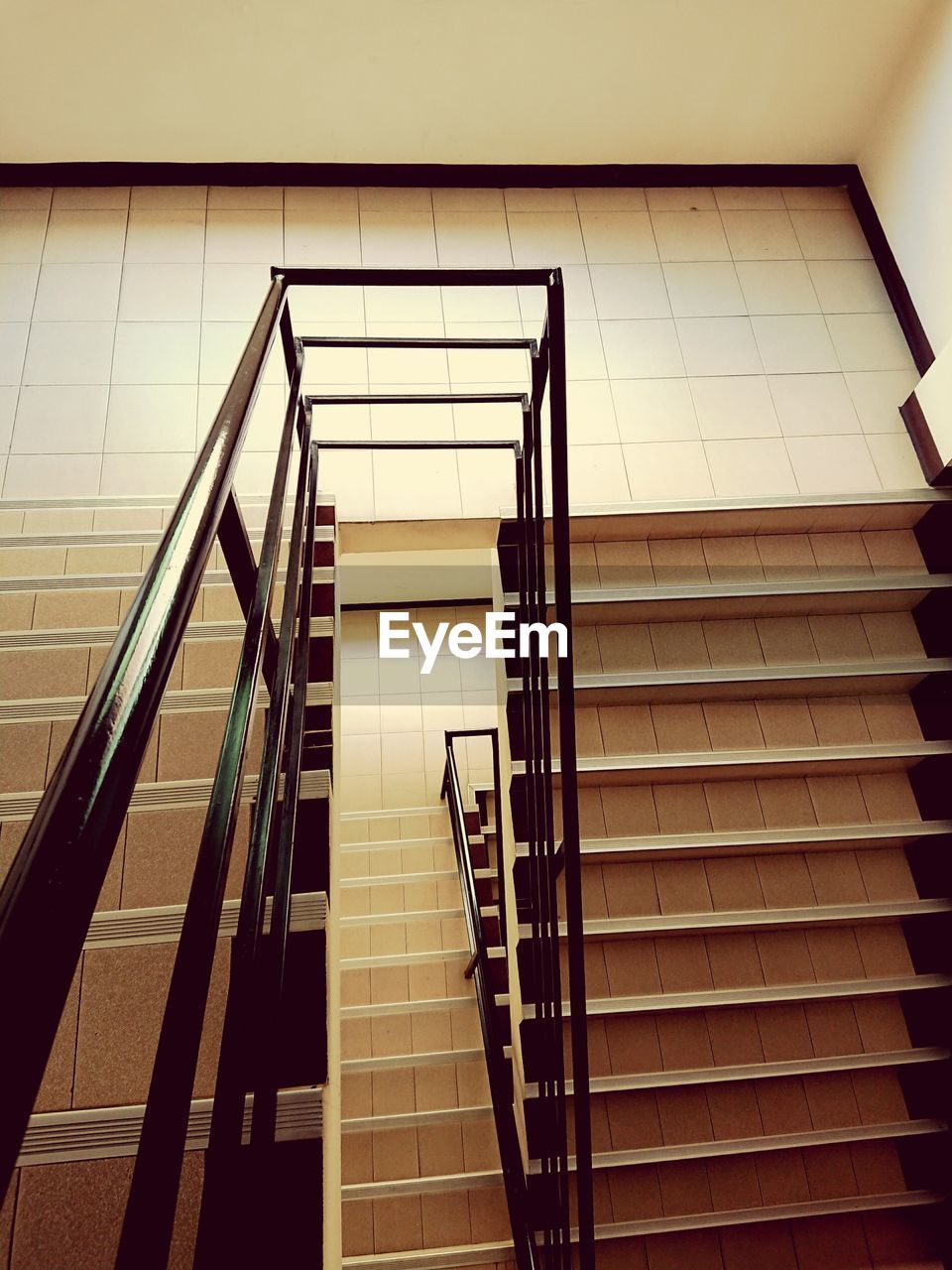 LOW ANGLE VIEW OF STAIRS AND SPIRAL STAIRCASE