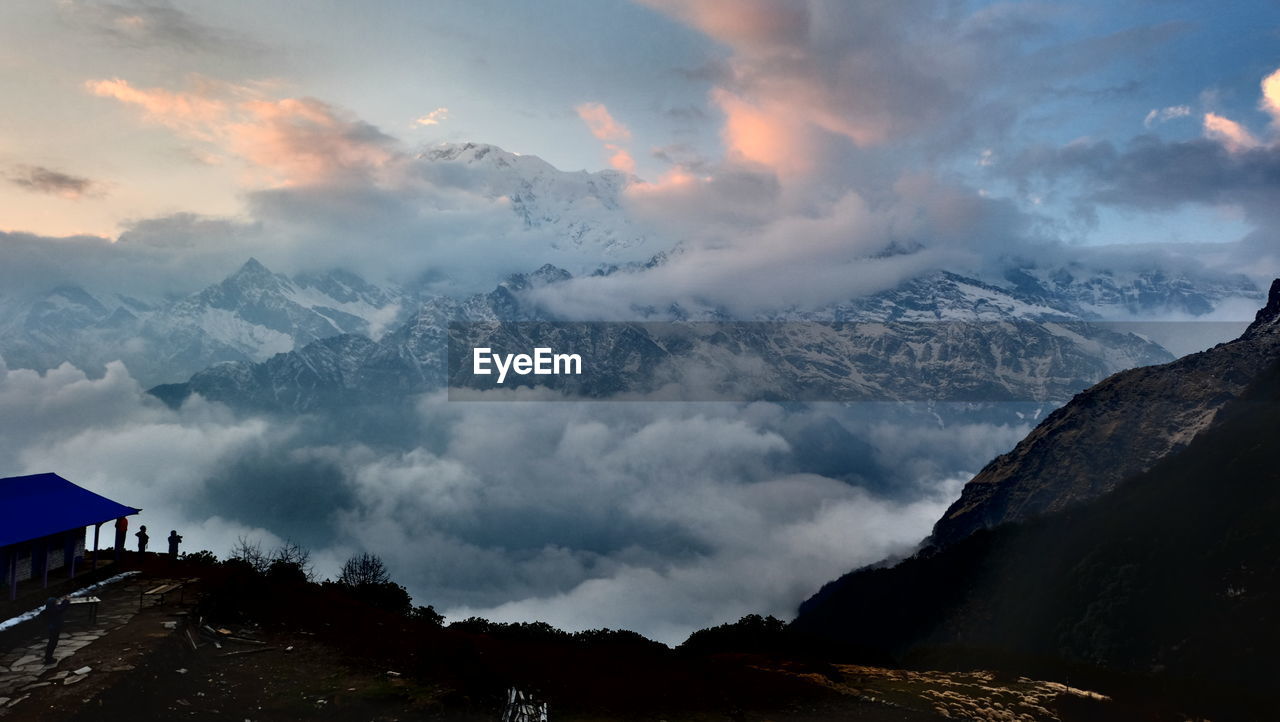 Scenic view of annapurna massif against cloudy sky