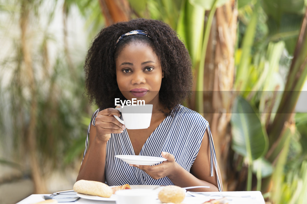 Portrait of young woman using mobile phone