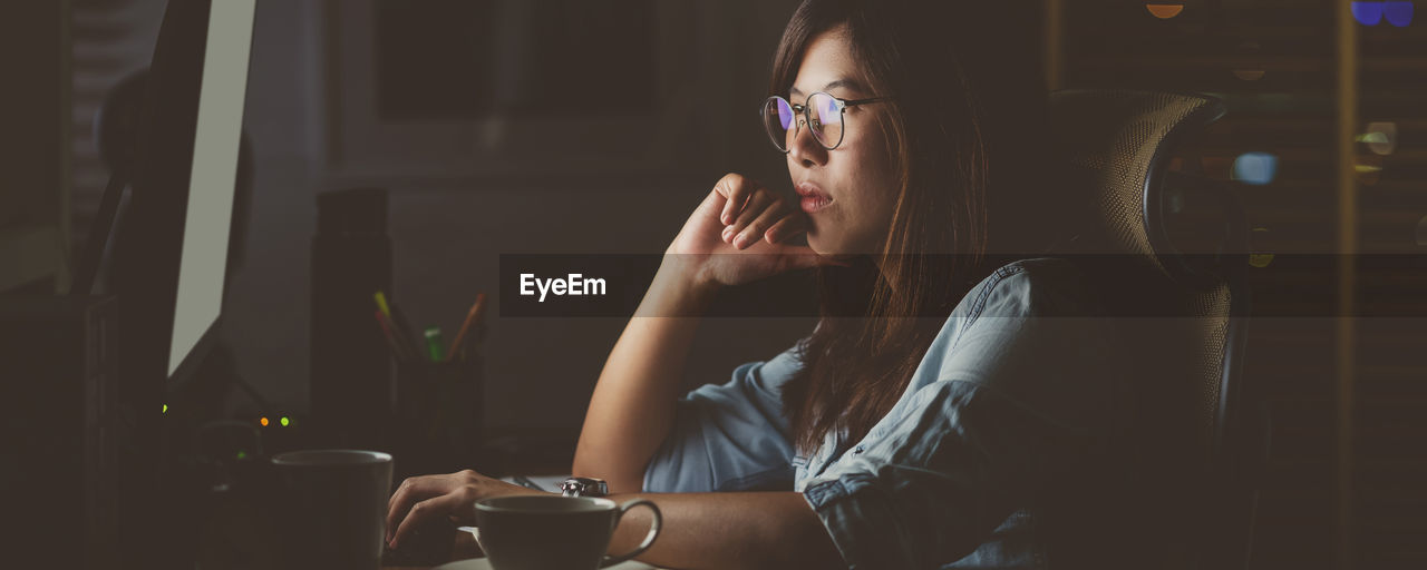 Thoughtful woman using computer