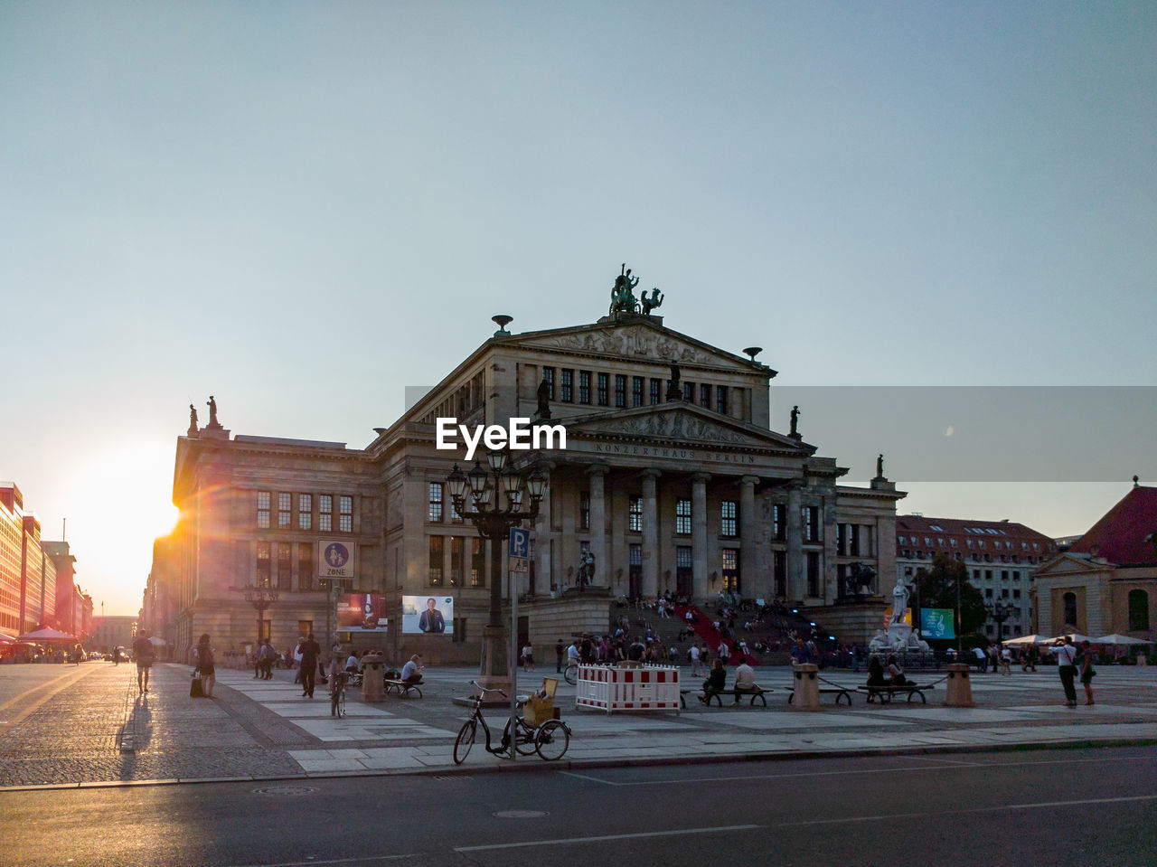 Street by schauspielhaus against clear sky during sunset 