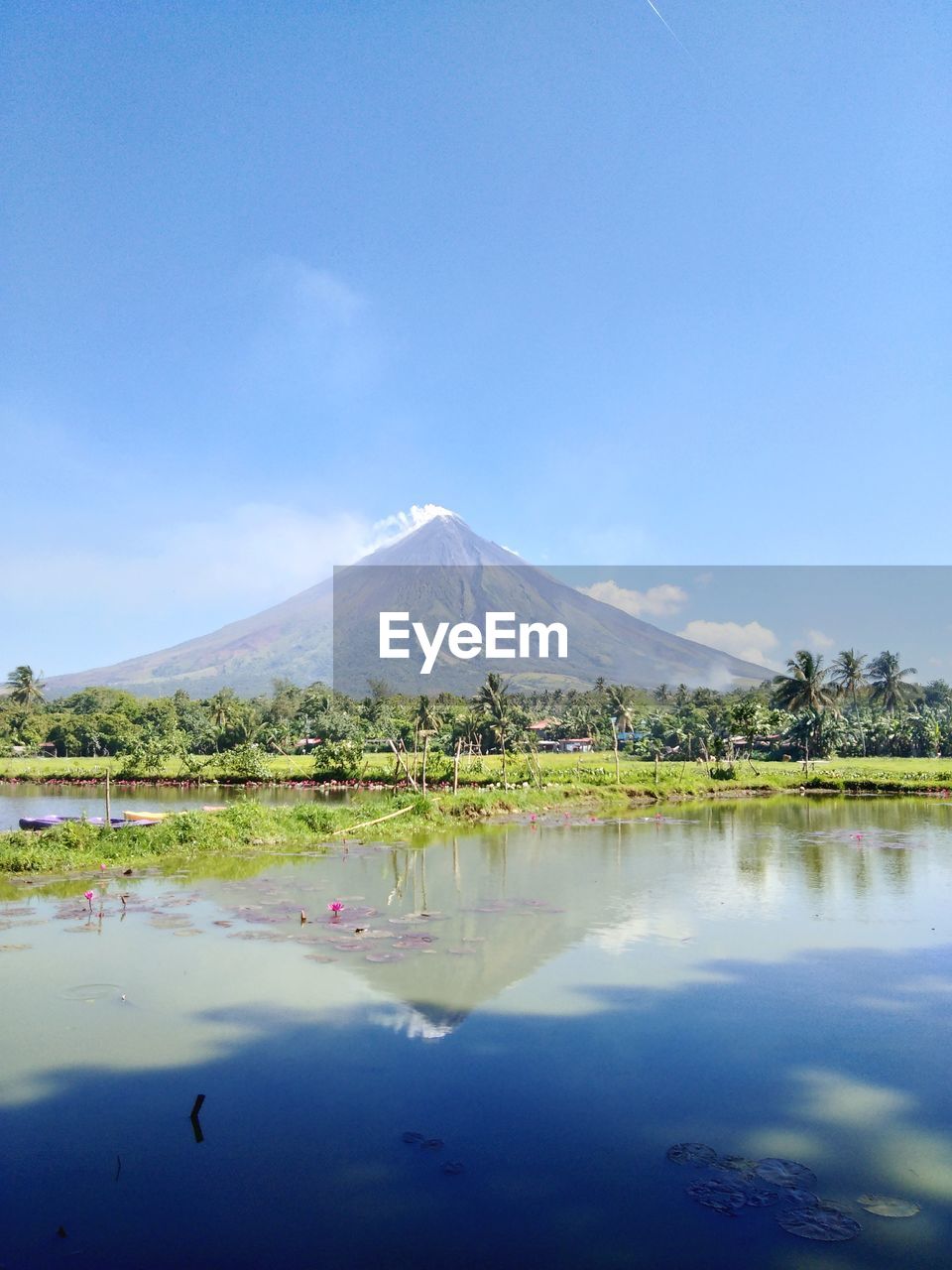 Scenic view of lake by mountains against sky