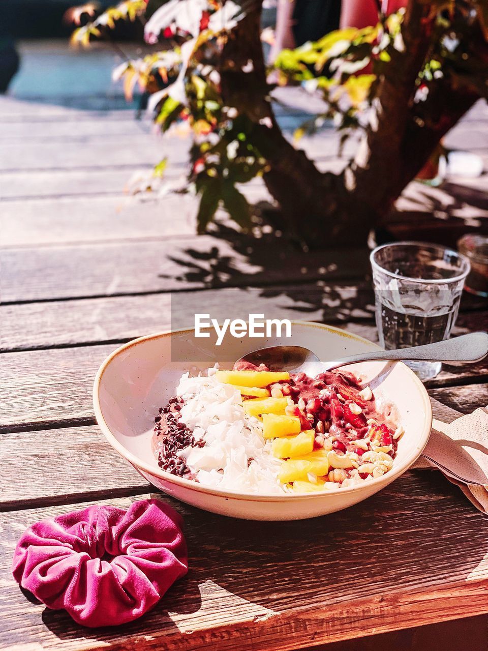 Close-up of healthy breakfast bowl meal served on a wooden table outside