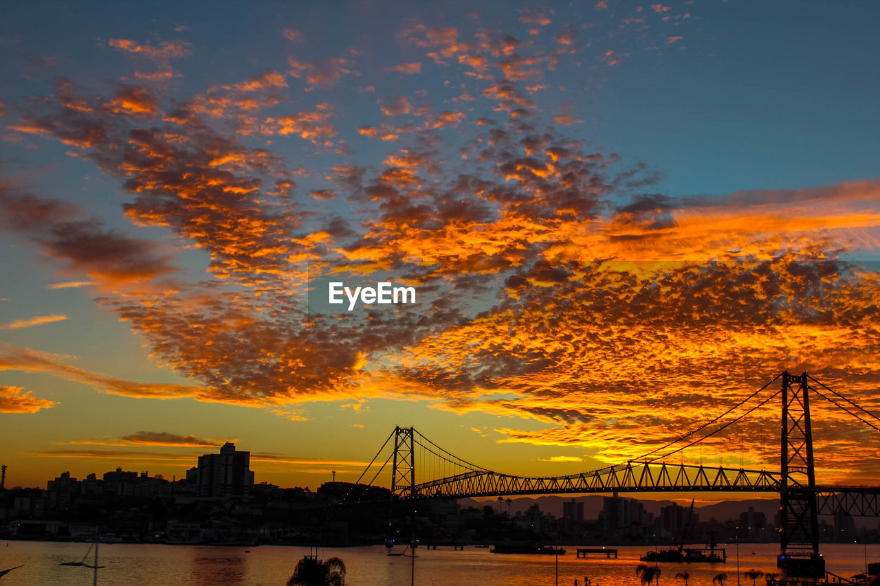 Silhouette of suspension bridge during sunset