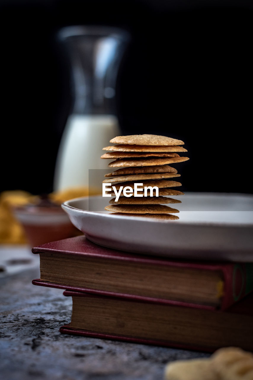 Stack of books and cookies on the table