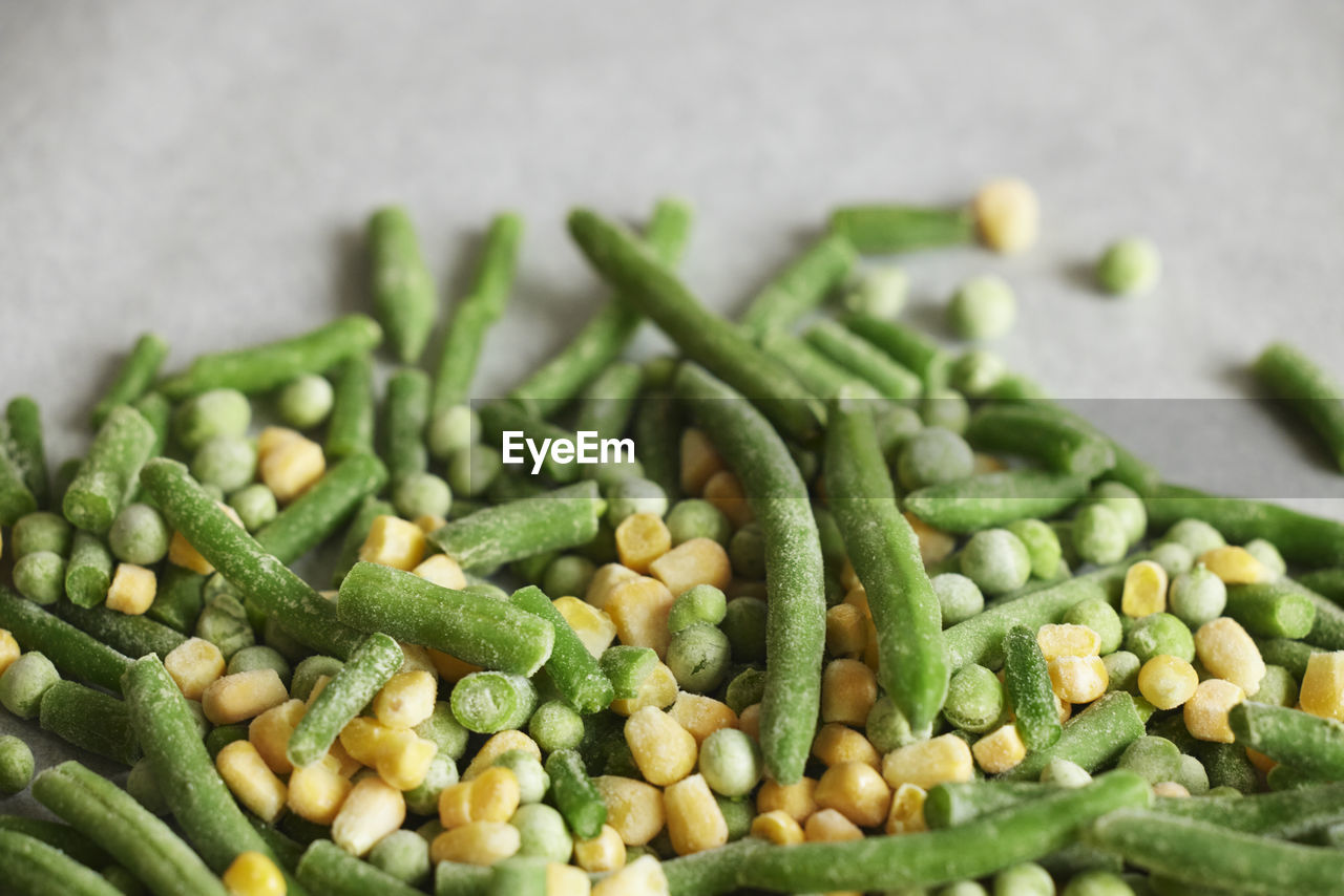 Heap of frozen green beans, peas, and corn