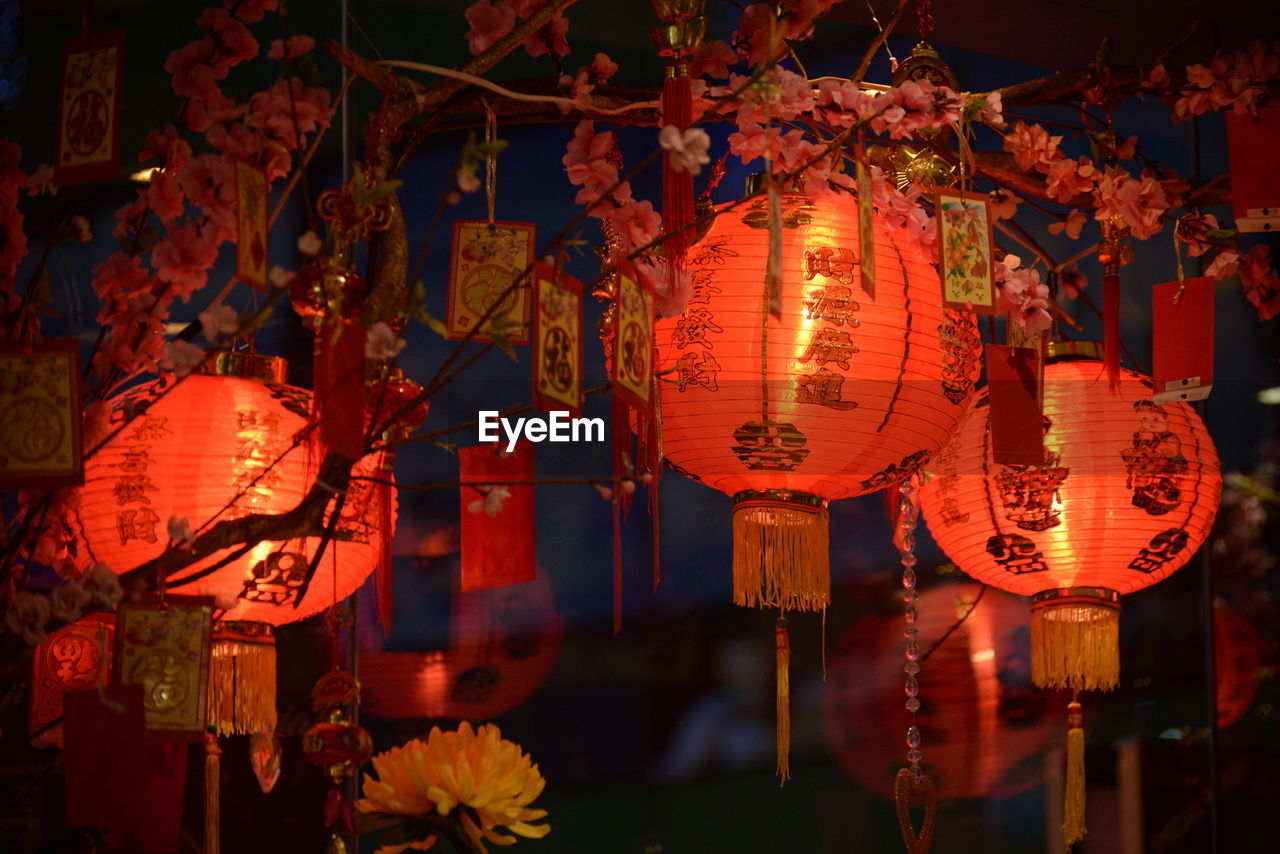 ILLUMINATED LANTERN HANGING AT NIGHT