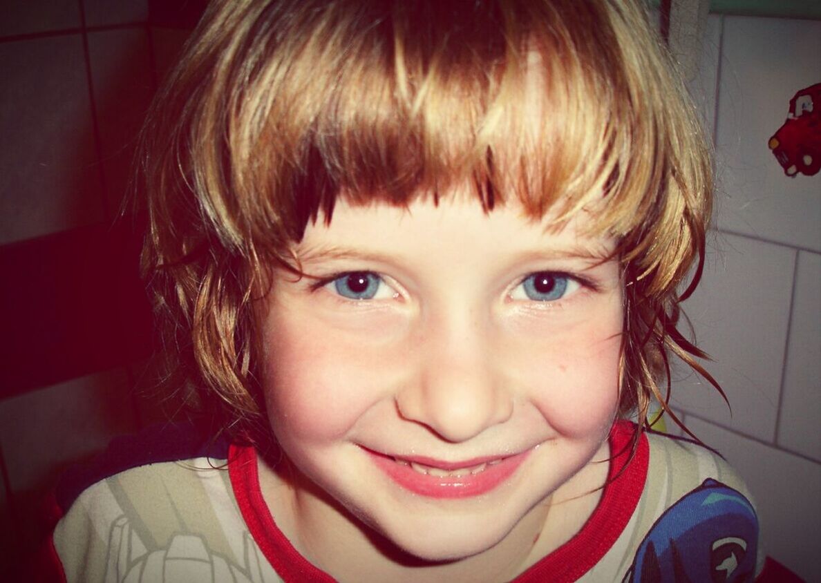 Portrait of happy boy with blue eyes