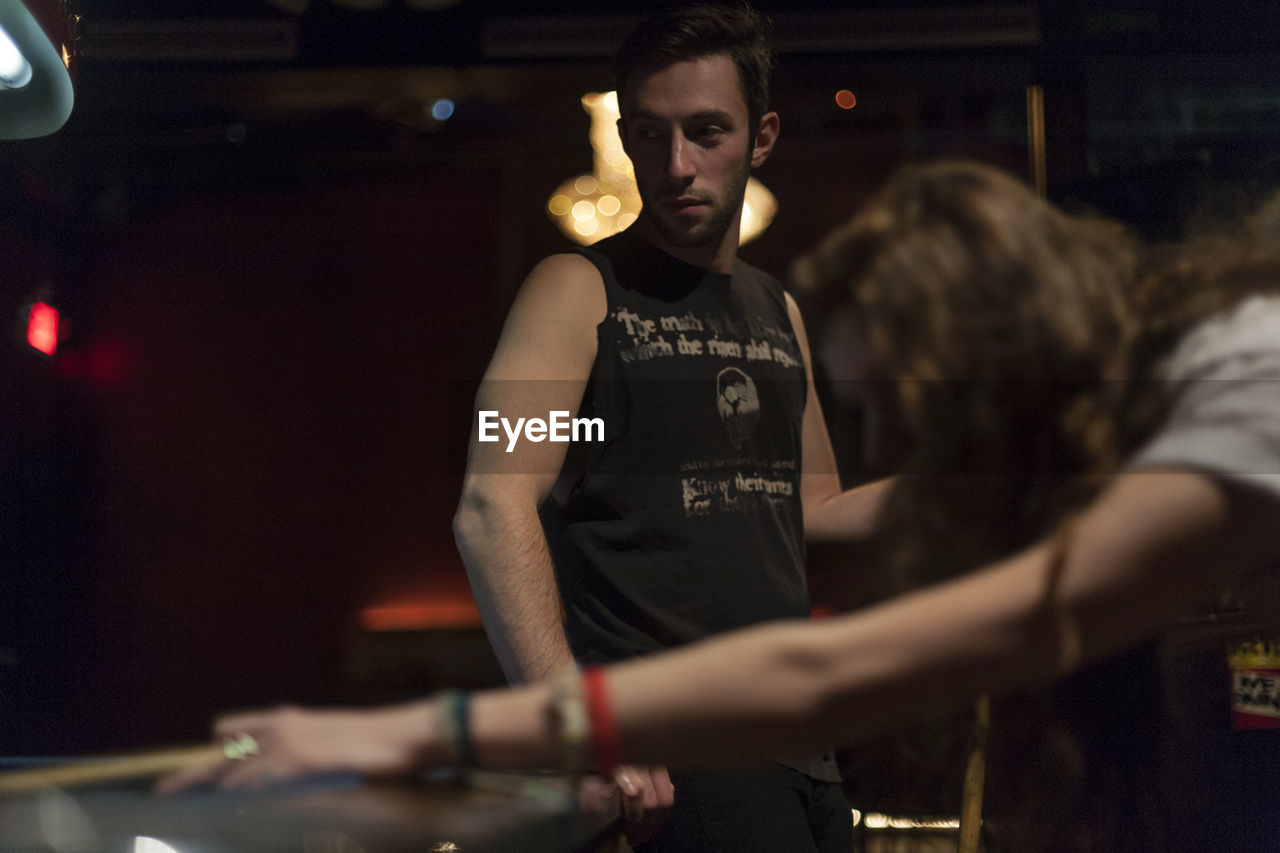 Young couple hanging out at a pool hall