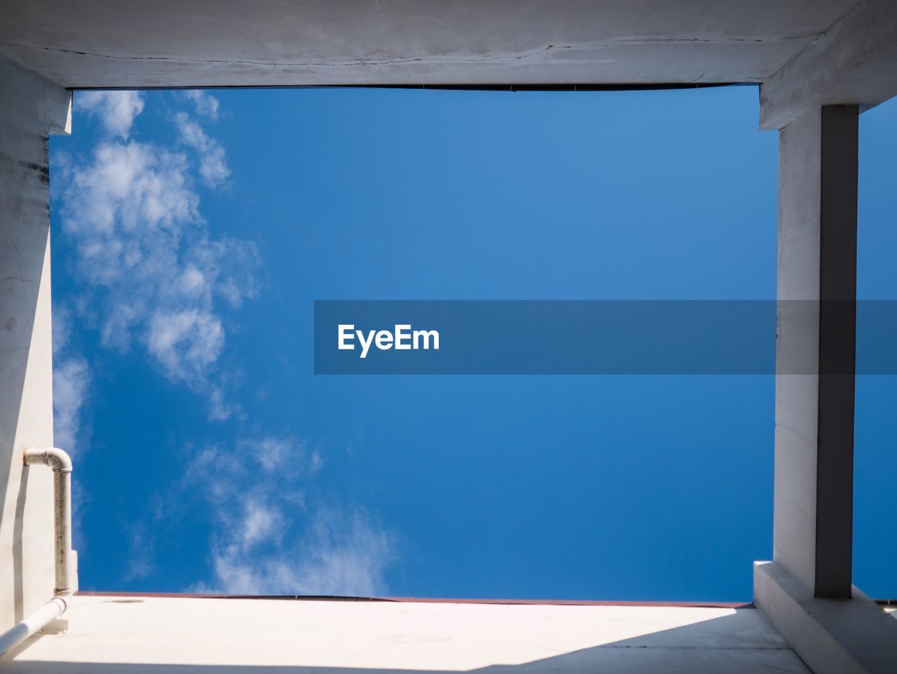 LOW ANGLE VIEW OF BLUE WINDOW AGAINST SKY