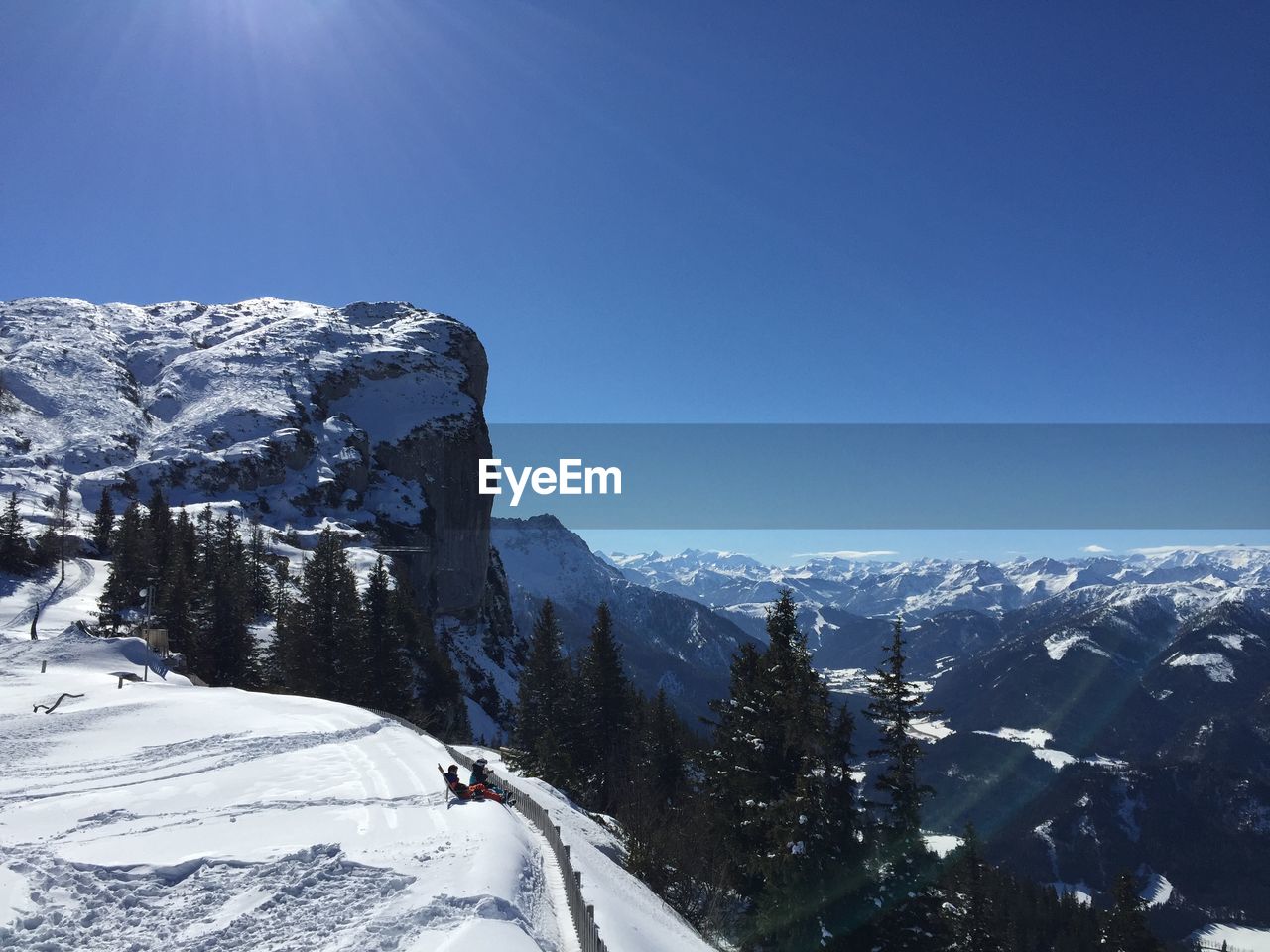 Scenic view of snowcapped mountains against clear blue sky