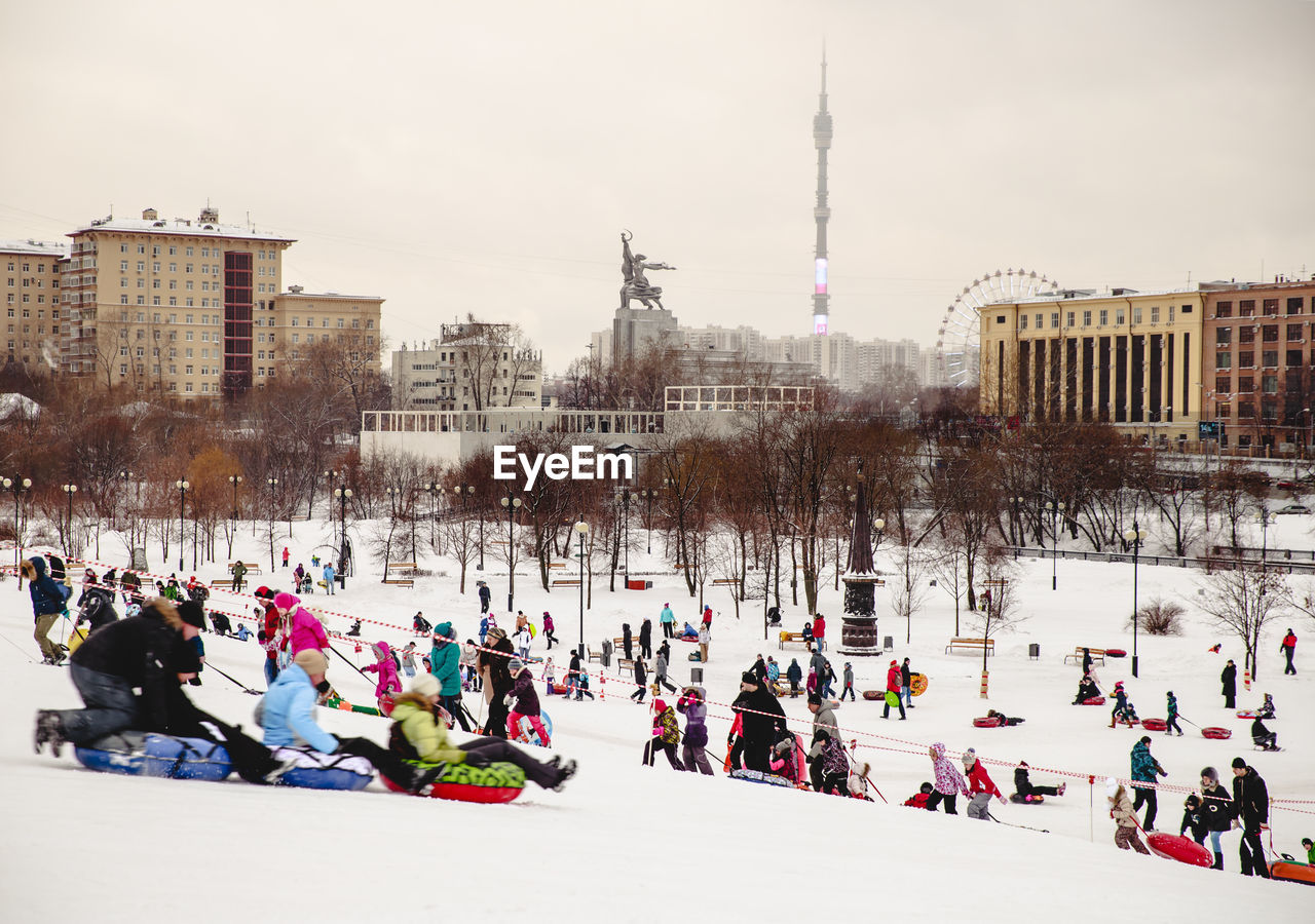 Distant view of ostankino tower in front of people enjoying during winter in city