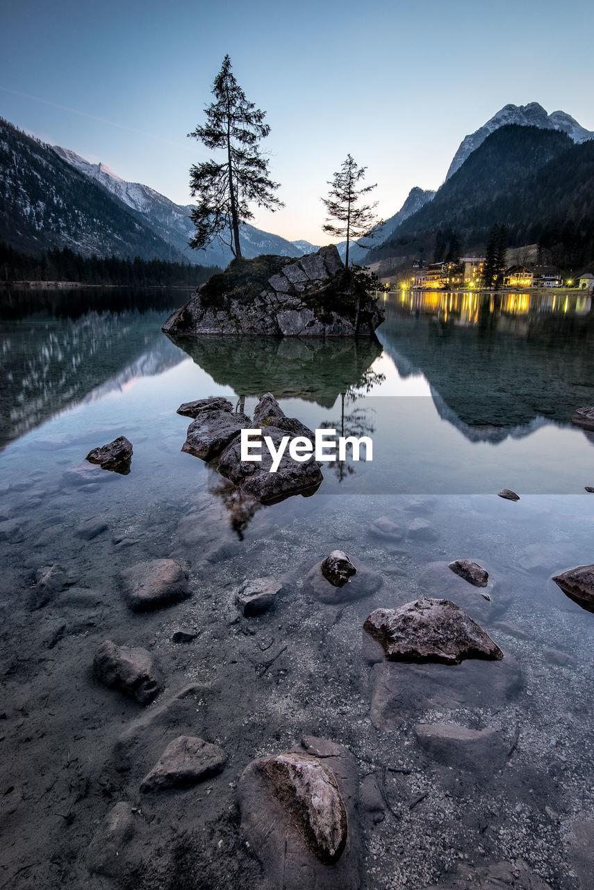 Scenic view of lake against sky at sunset