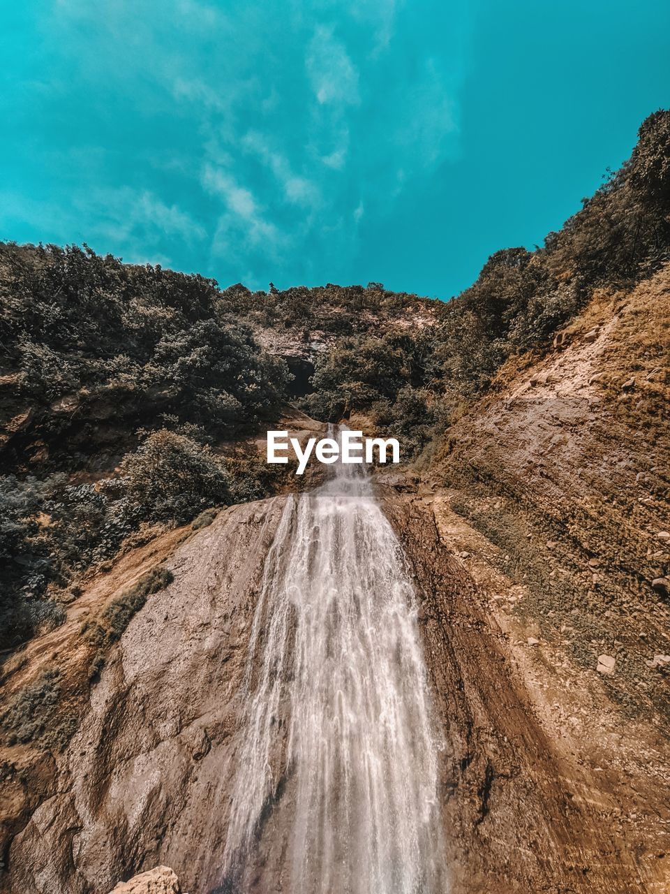 Scenic view of waterfall against sky