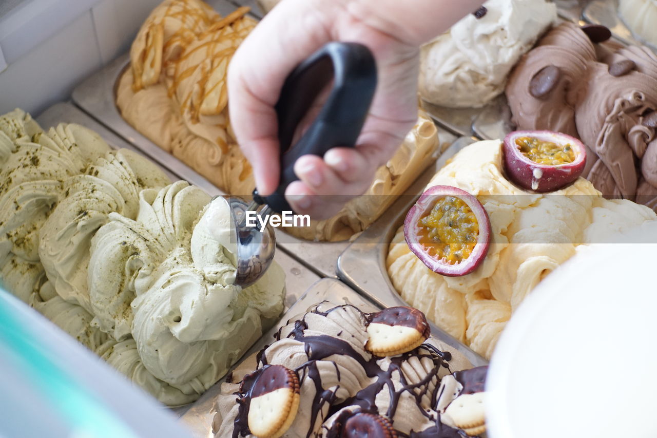 HIGH ANGLE VIEW OF WOMAN HOLDING FOOD