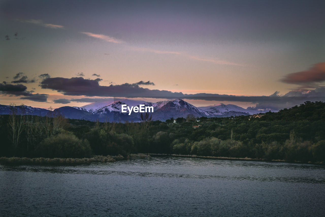 Scenic view of lake against sky during sunset