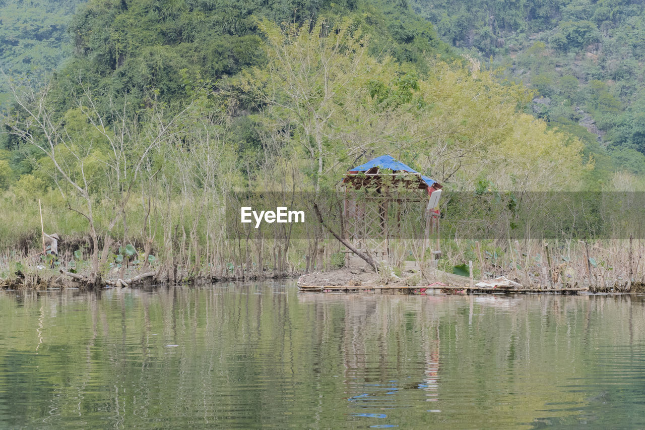 PERSON IN LAKE AGAINST SKY